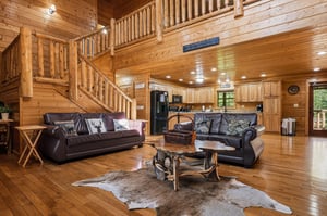 Unwind in this stunning log cabin with rustic leather sofas and an open loft design that feels like your own mountain retreat.