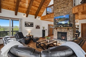 Sink into plush leather seating by the crackling stone fireplace, surrounded by soaring woodbeam ceilings and sweeping mountain views through expansive windows.