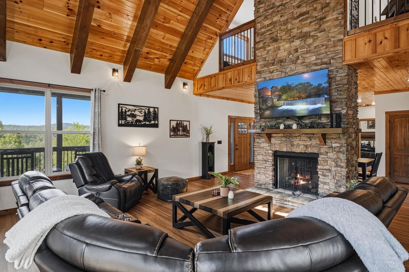 Sink into plush leather seating by the crackling stone fireplace, surrounded by soaring woodbeam ceilings and sweeping mountain views through expansive windows.