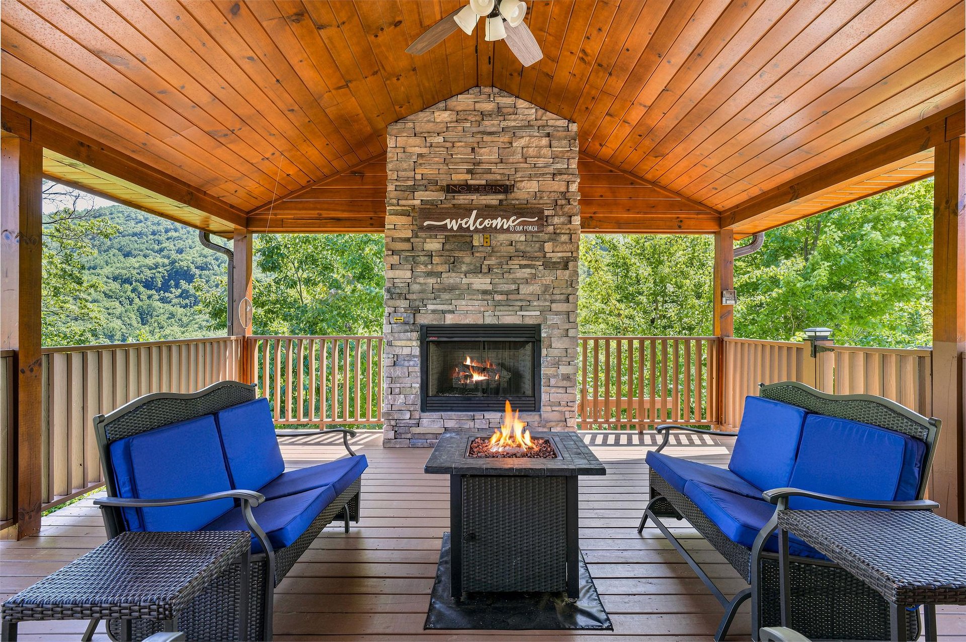 Relax on your covered deck with a warm fire, mountain breezes, and a welcoming stone fireplace framing your perfect mountain getaway.