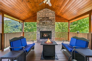 Relax on your covered deck with a warm fire, mountain breezes, and a welcoming stone fireplace framing your perfect mountain getaway.
