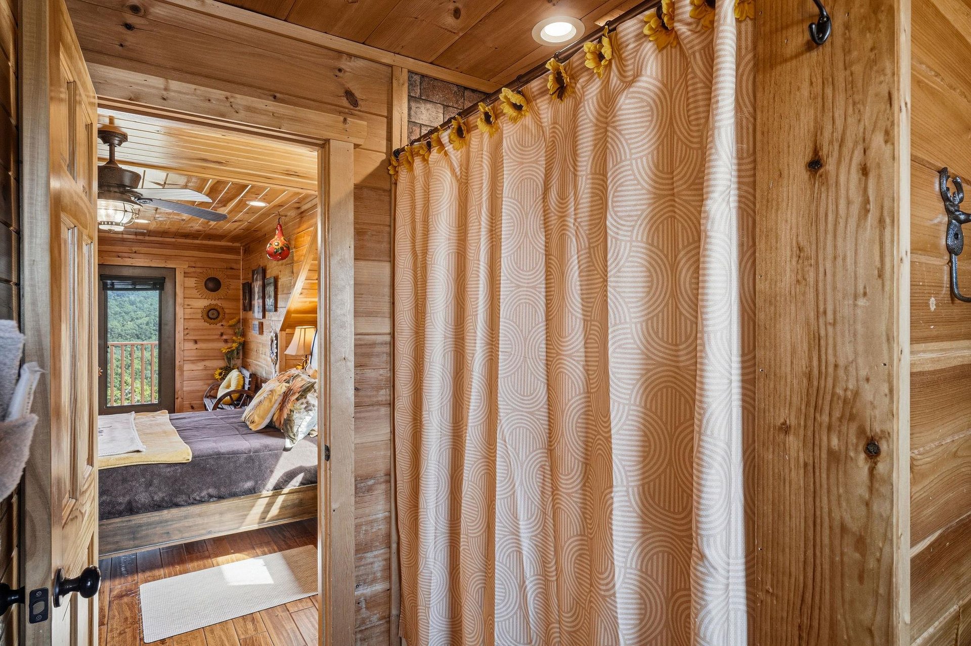 Warm wood surrounds you in this cozy bathroom, where natural textures and soft lighting create a serene retreat after a day of mountain adventures.