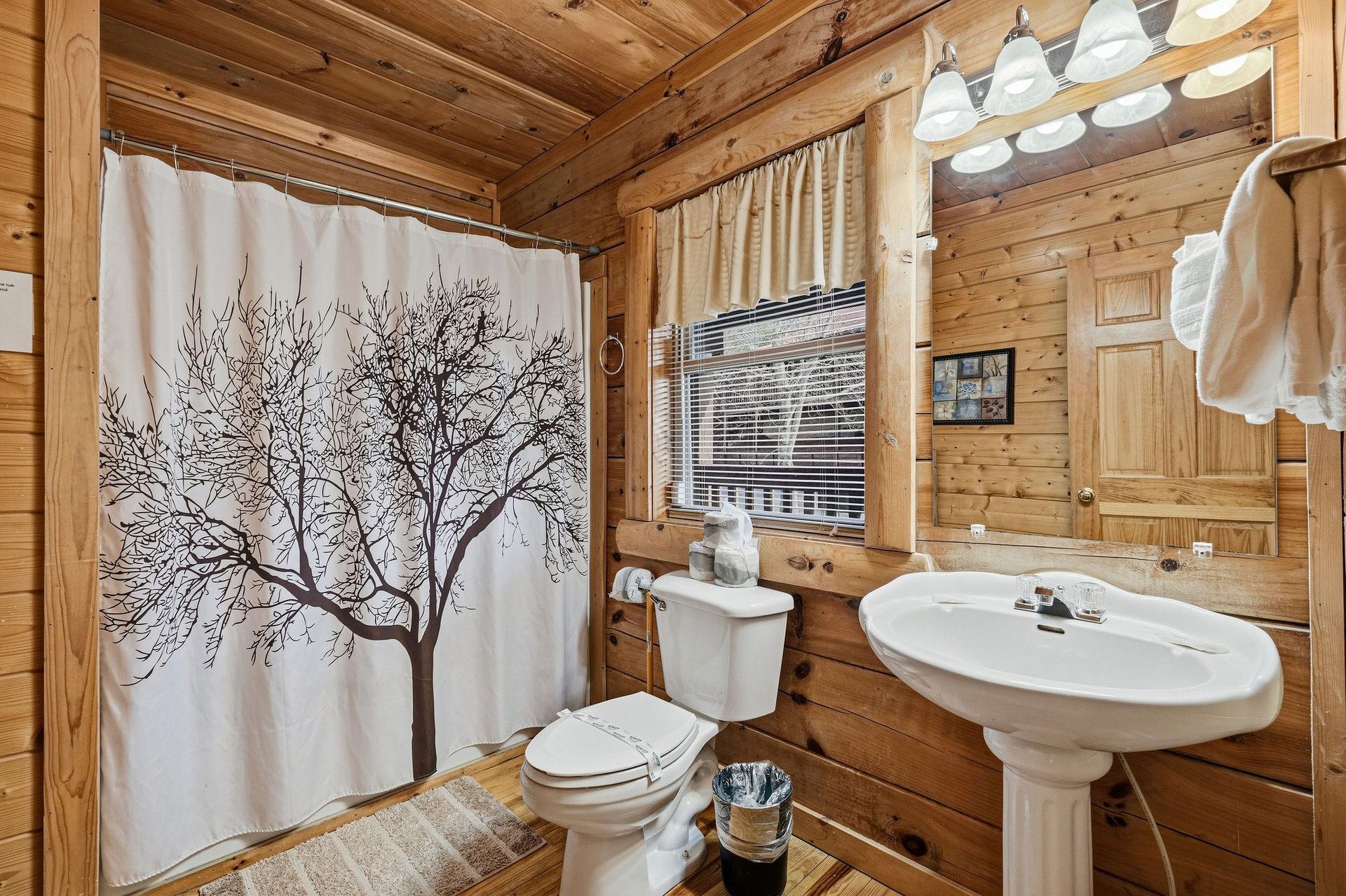 Step into your rustic cabin bathroom where warm wood walls create a cozy atmosphere for your refreshing morning routines.