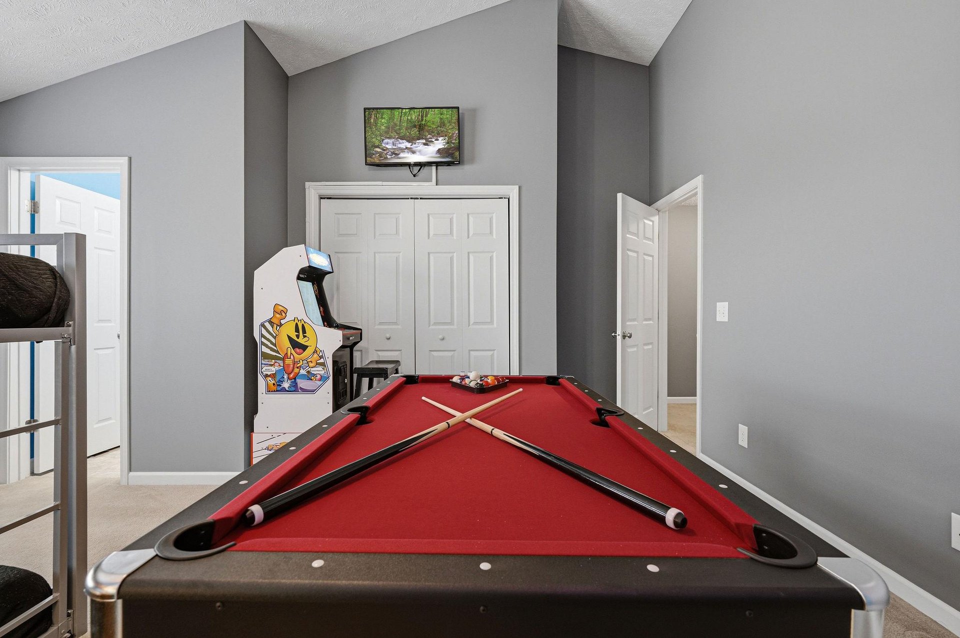 Challenge your friends to a game of pool in your private game room, complete with vintage arcade fun and a TV for entertainment breaks.