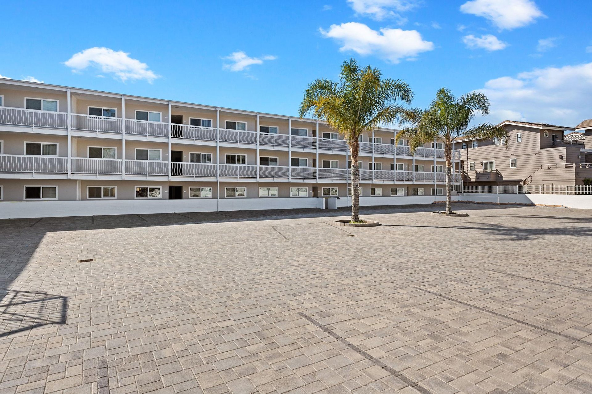 Carpinteria Shores with new brick paver parking lot, and newly painted building.