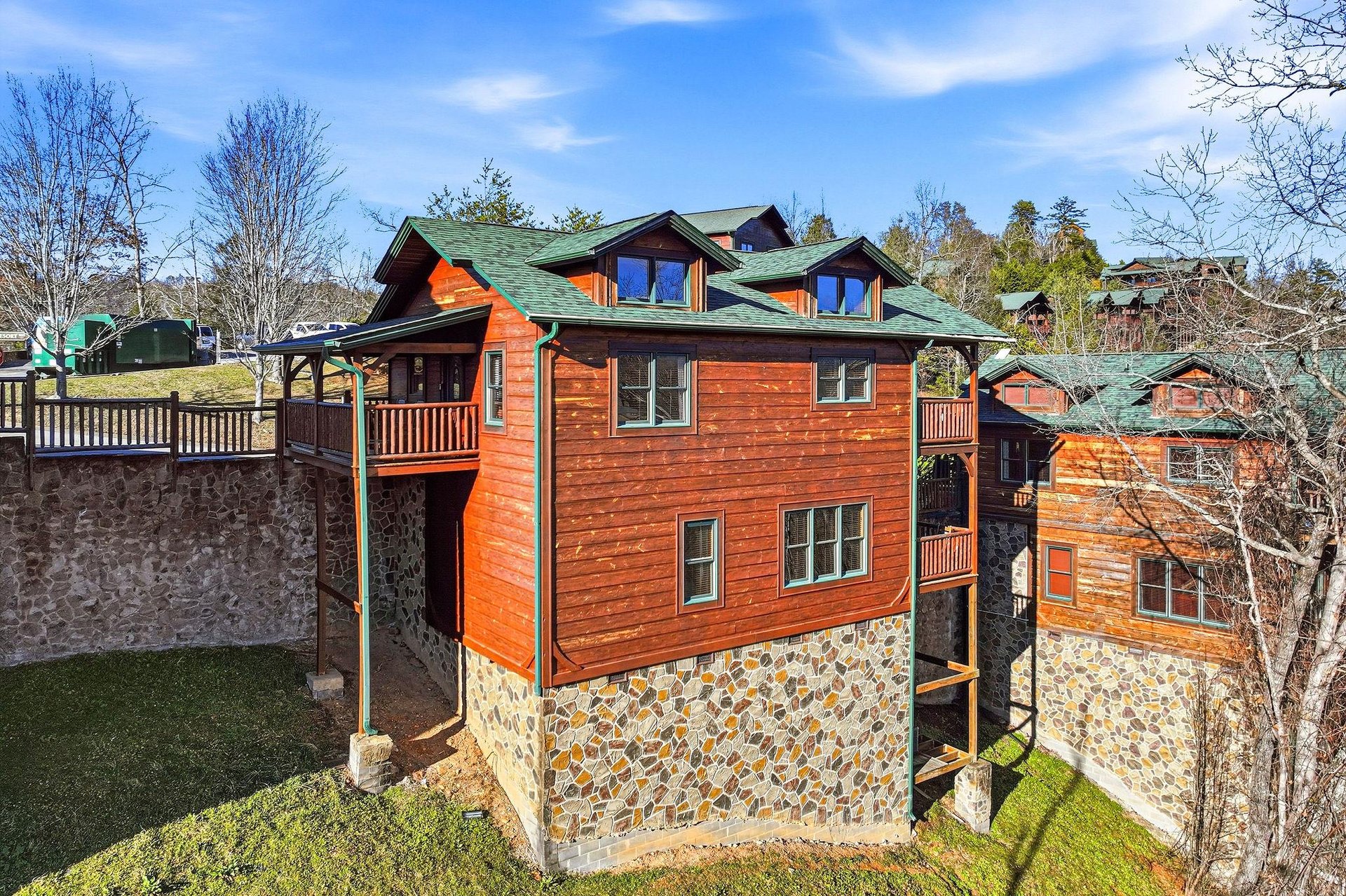 Charming mountain lodge with stone and wood exterior featuring multiple levels and balconies.