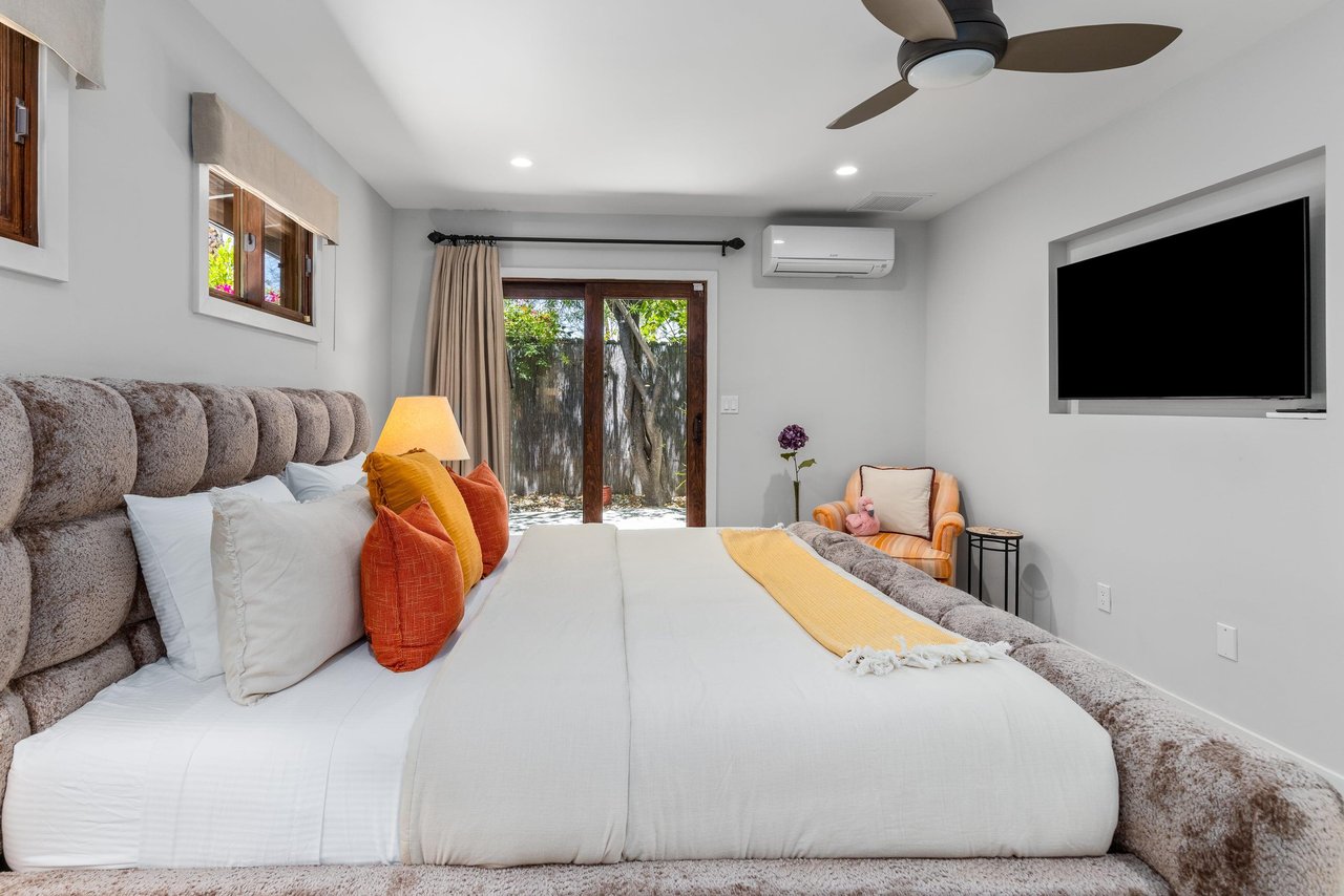 King bed, Smart TV, patio access, and ensuite bathroom.