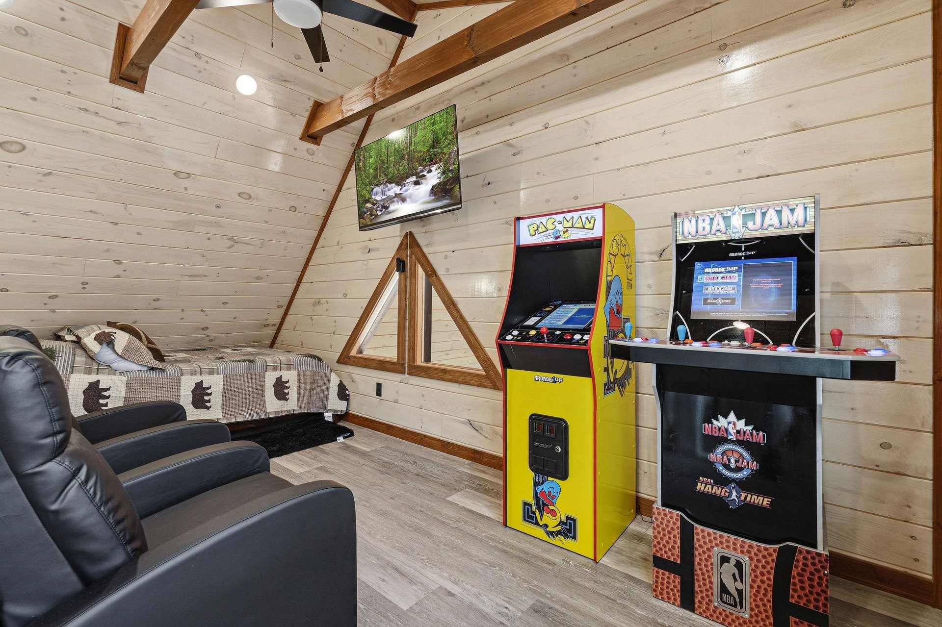 Challenge friends to classic arcade games in your cozy loft game room, complete with comfy seating and rustic charm.