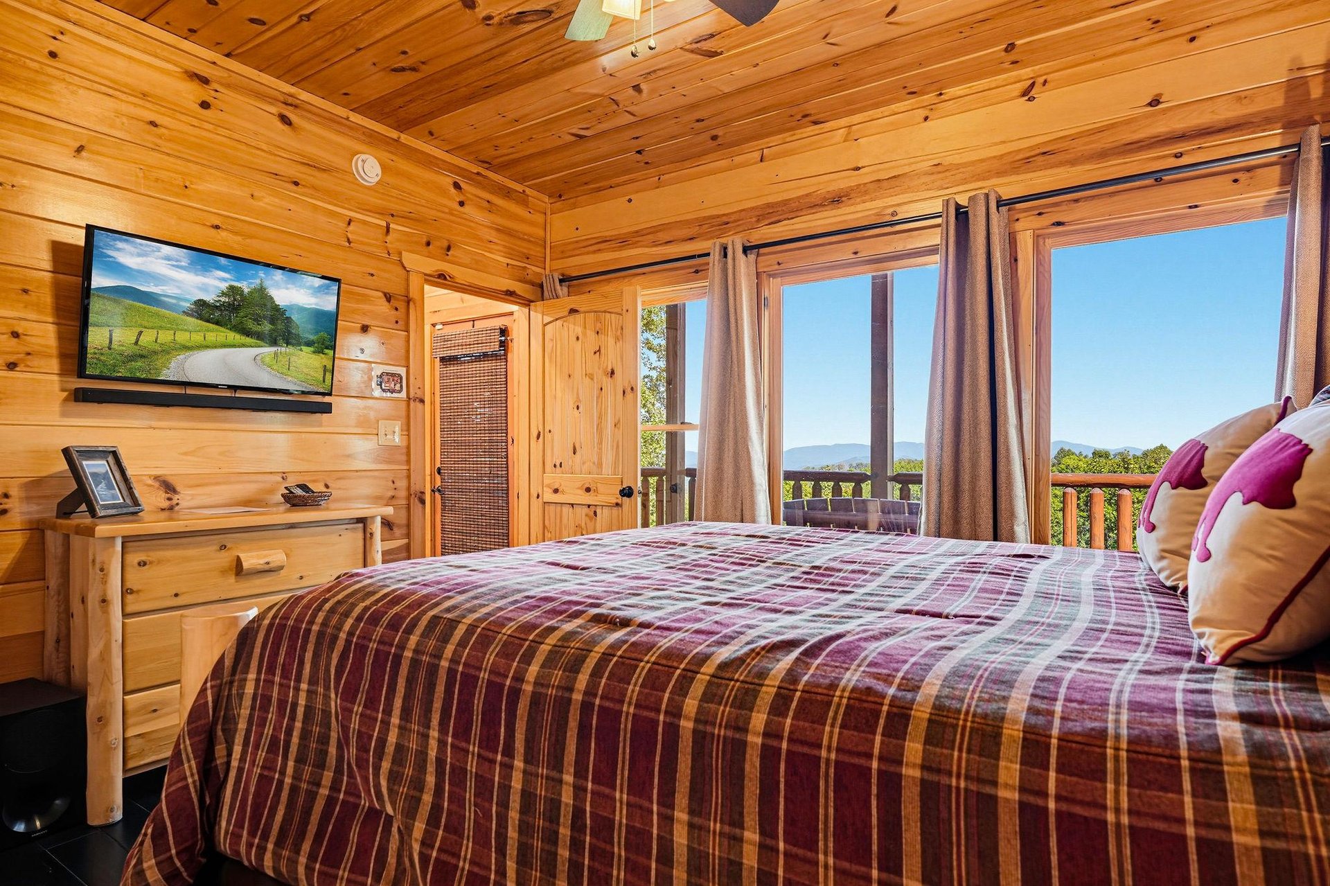 Wake up to stunning mountain vistas framed by your bedrooms expansive windows. The warm knotty pine surrounds you as natural light fills this cozy retreat, where rustic charm meets breathtaking views