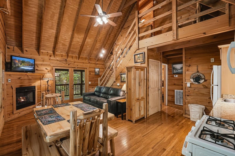 Unwind in your cozy cabin retreat, featuring soaring vaulted ceilings, a crackling fireplace, and a charming loft perfect for relaxing after mountain adventures.