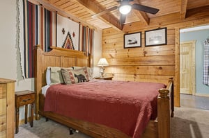 Slip into the inviting comfort of a rustic retreat with a handcrafted wooden bed, warm knotty pine walls, and southwestern textiles that wrap you in cozy, mountaininspired charm.