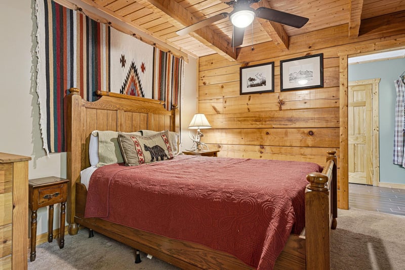 Slip into the inviting comfort of a rustic retreat with a handcrafted wooden bed, warm knotty pine walls, and southwestern textiles that wrap you in cozy, mountaininspired charm.