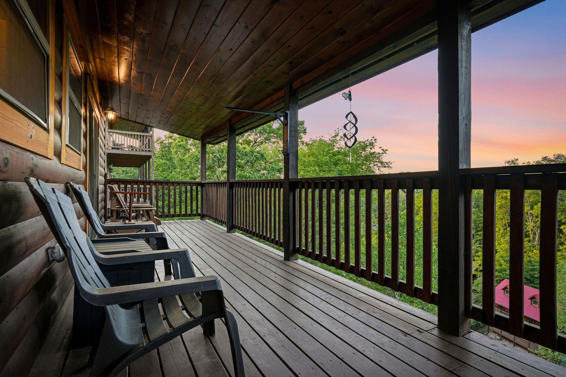 Unwind on your private deck as evening colors paint the sky above lush treetops, perfect for morning coffee or sunset relaxation.