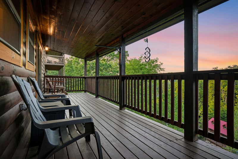 Unwind on your private deck as evening colors paint the sky above lush treetops, perfect for morning coffee or sunset relaxation.