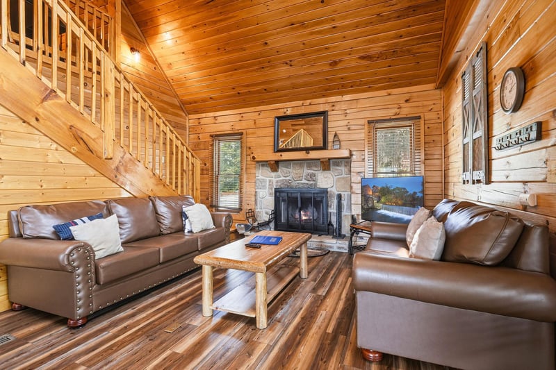 Youll love relaxing in this warm cabin retreat, with rich wood tones, plush leather seating, and a cozy stone fireplace inviting you to unwind after a day of adventure.
