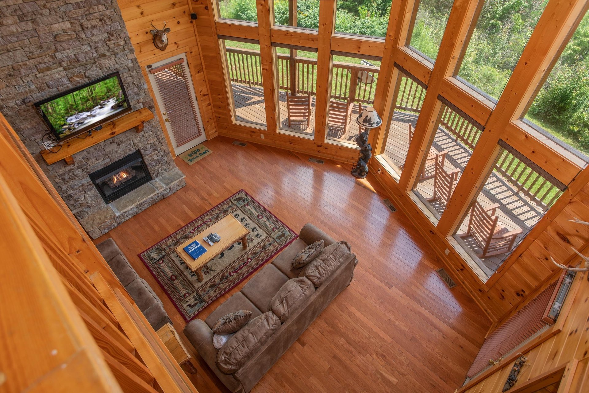 Looking down into the living room from the upper floor at Four Seasons Lodge, a 3bedroom cabin rental located in Pigeon Forge