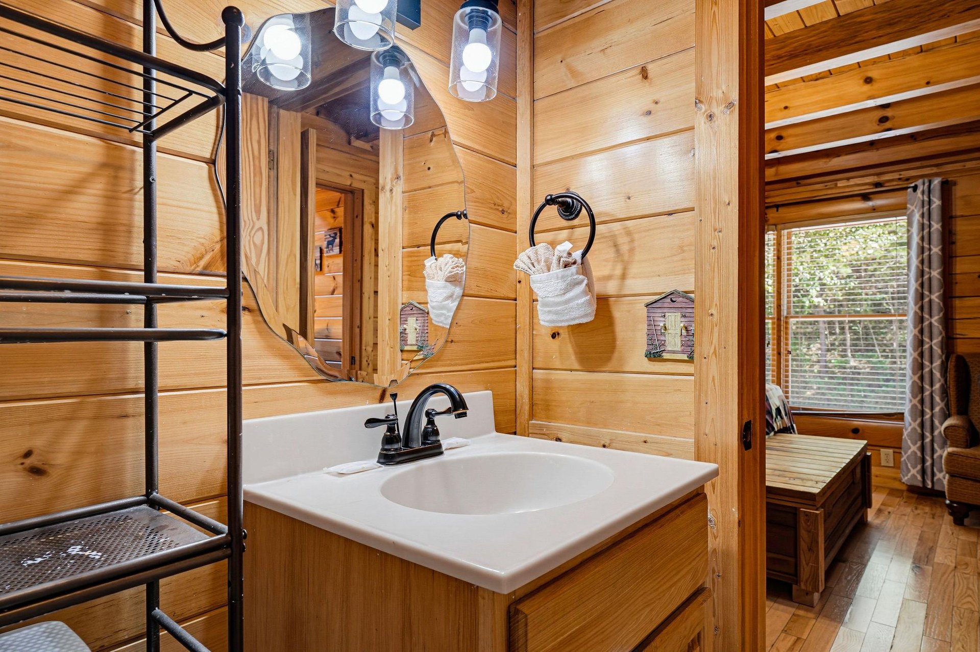 Step into your cozy cabin retreat, where warm wood walls surround a fresh bathroom with modern fixtures and thoughtful touches. Natural light and rustic charm create the perfect escape.