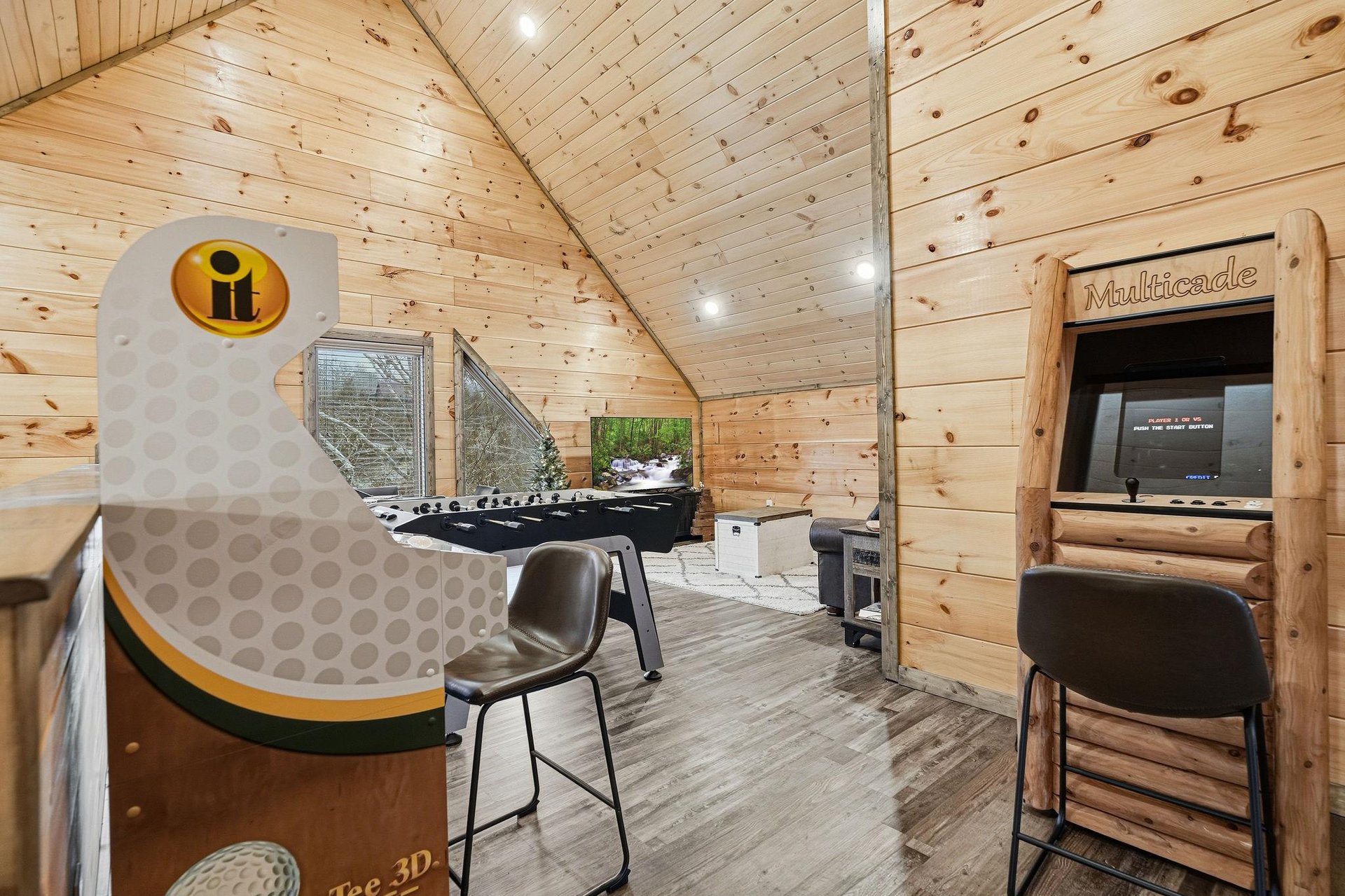 Challenge friends to arcade games in your cozy entertainment loft with vintage games and warm wood ambiance.