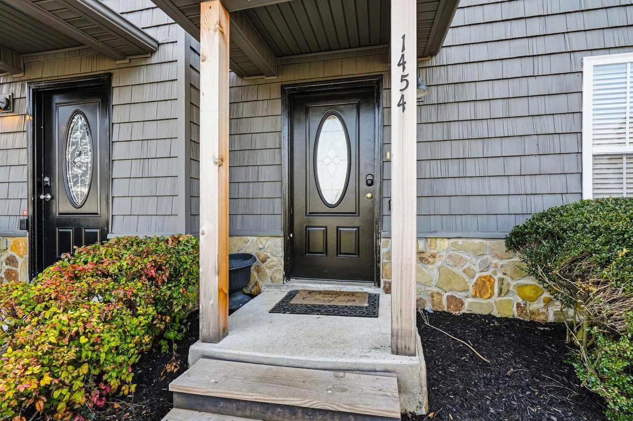 Welcoming front entrance with natural stone accents and seasonal landscaping at 1454.