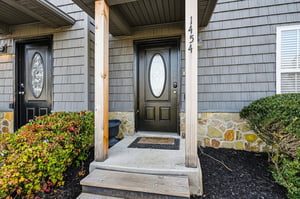Welcoming front entrance with natural stone accents and seasonal landscaping at 1454.