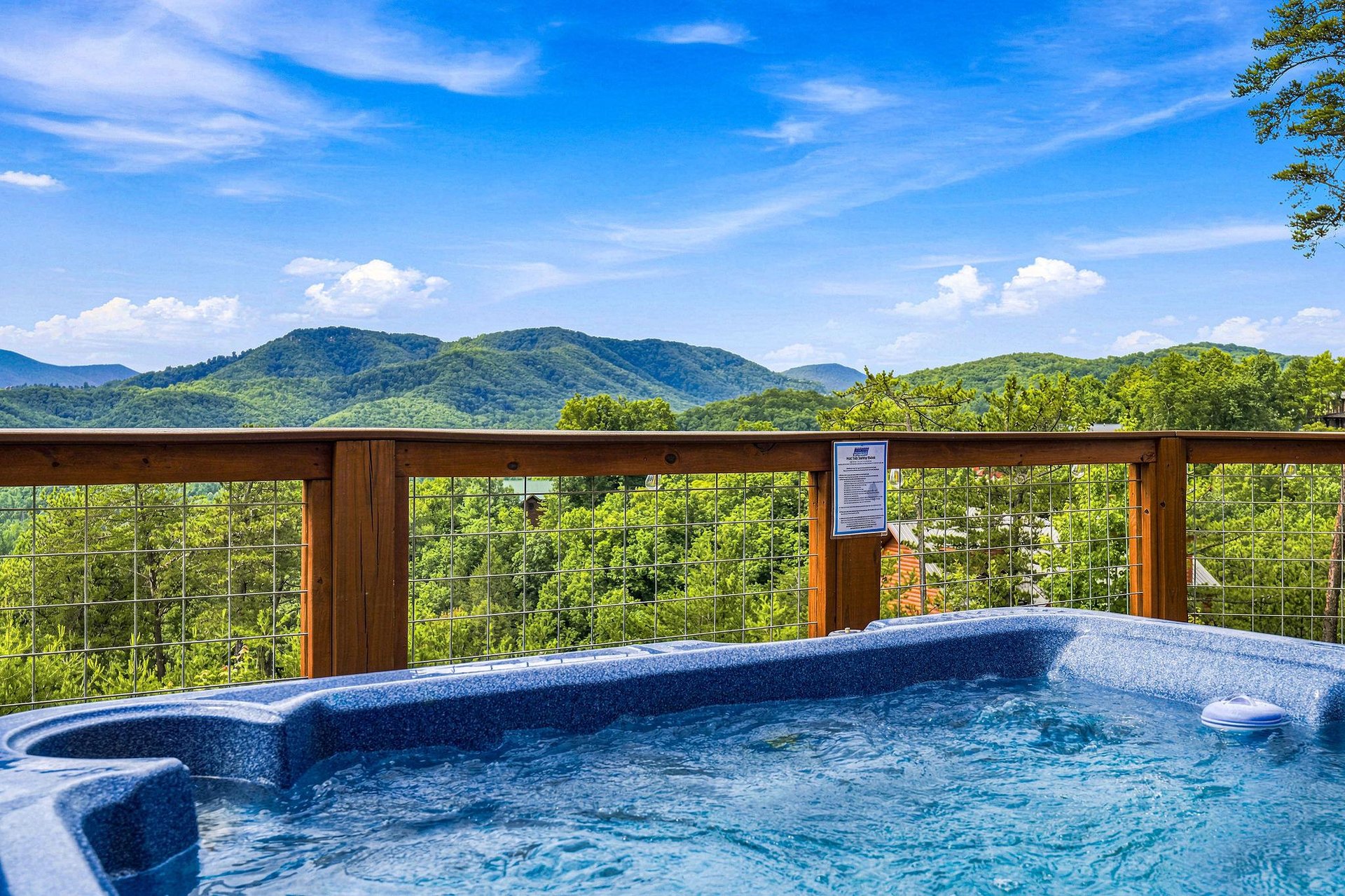 Soak away your cares in the hot tub while drinking in panoramic mountain views beneath an open sky.