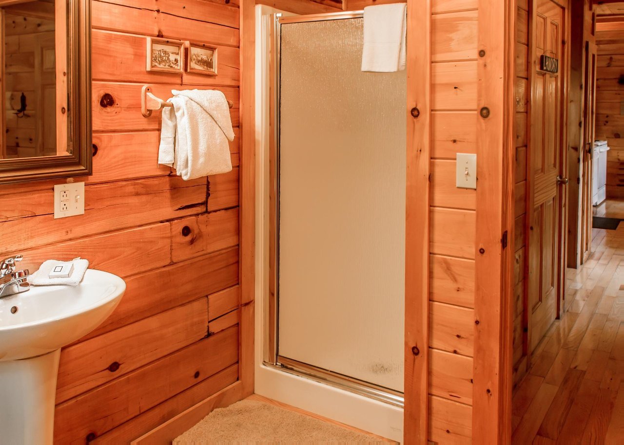 The full bathroom on the first floor features a shower stall and pedestal sink.