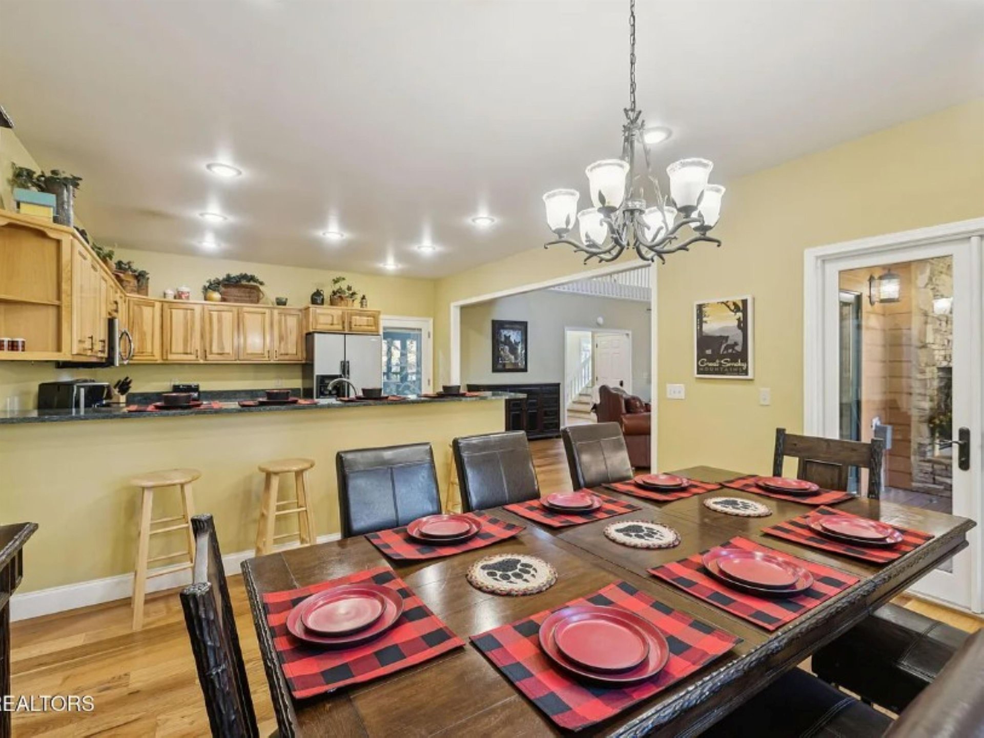 Gather around this spacious dining table where your group can share meals and stories. The open kitchen layout keeps everyone connected while you cook and entertain together.