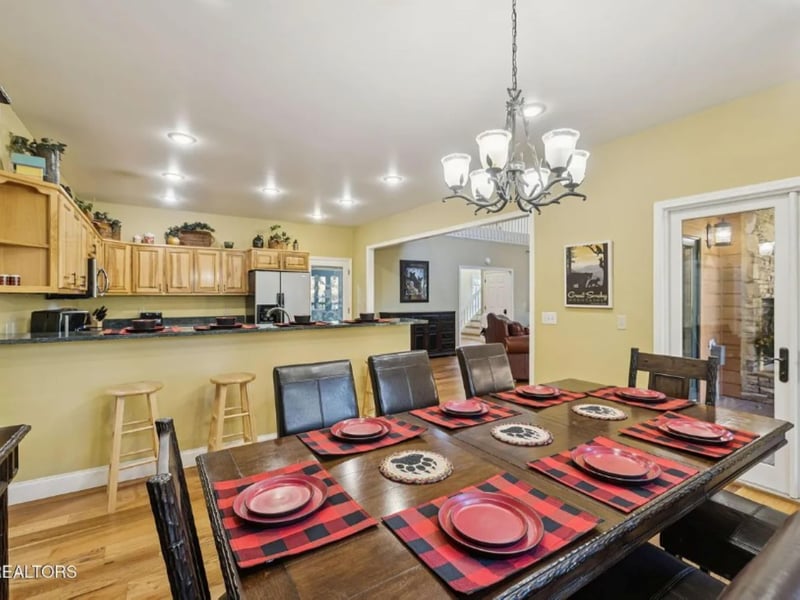 Gather around this spacious dining table where your group can share meals and stories. The open kitchen layout keeps everyone connected while you cook and entertain together.
