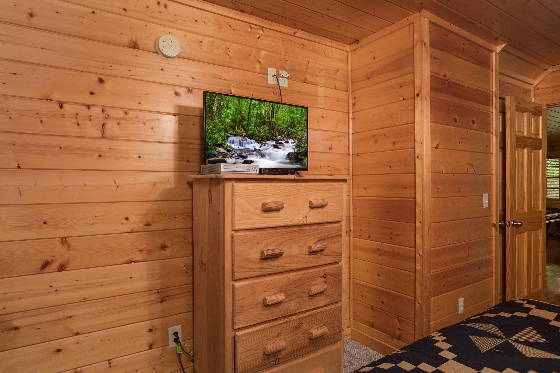 Dresser and TV in a bedroom at Kick Back  Relax A 4 bedroom cabin rental located in Pigeon Forge