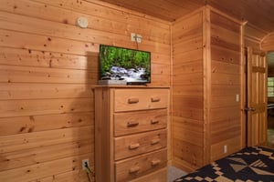 Dresser and TV in a bedroom at Kick Back  Relax A 4 bedroom cabin rental located in Pigeon Forge
