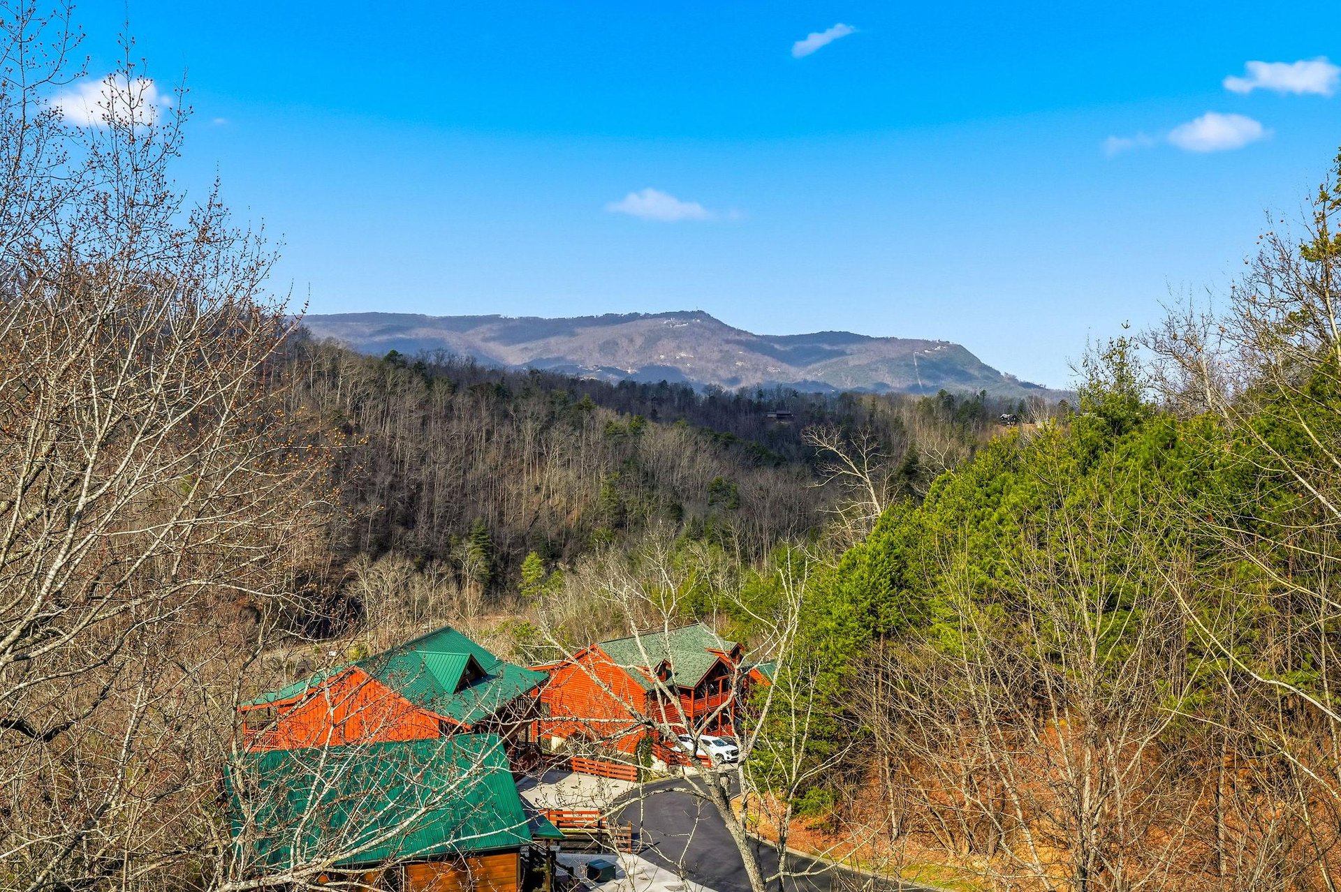Nestled in rolling mountain terrain, this property offers stunning natural surroundings with forested hills and peaceful valley views.