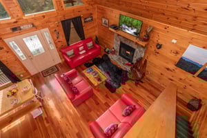Looking down into the living room from the upper floor at Hibernation Station, a 3bedroom cabin rental located in Pigeon Forge