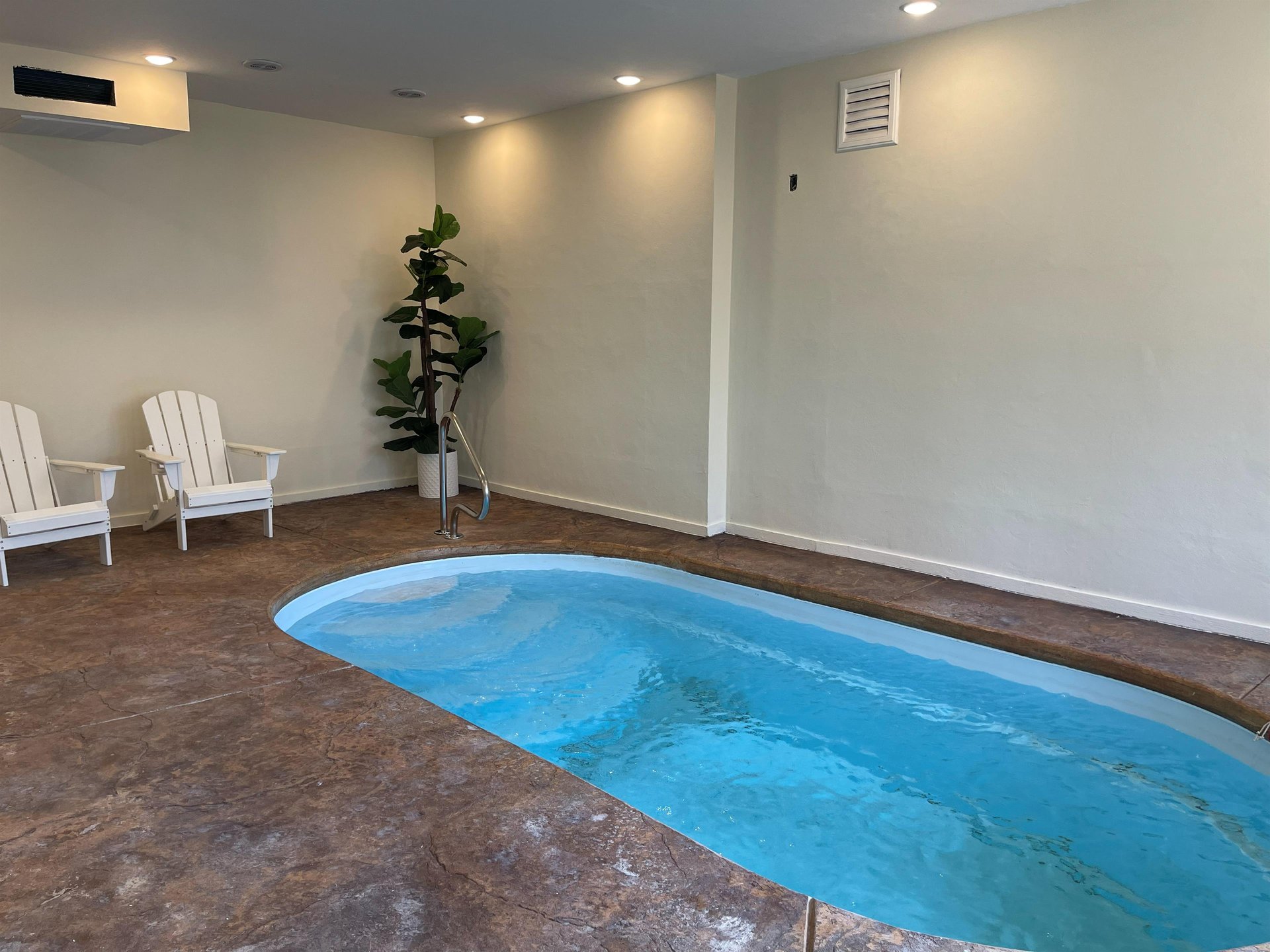 Dive into your private indoor oasis with crystalclear blue waters and poolside seating for ultimate relaxation.