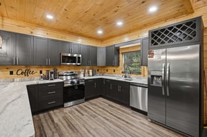 Your gourmet kitchen awaits with granite counters, stainless appliances, and charming wood accents perfect for cooking memorable meals.