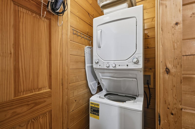 Your laundry stays fresh with convenient incabin washer and dryer, surrounded by warm wood walls.