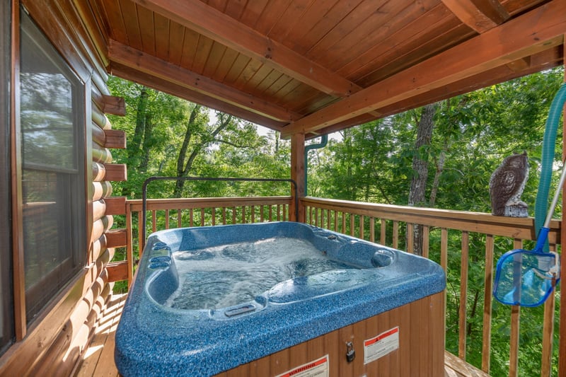 Hot tub on a covered deck at Grand View, a 3 bedroom cabin rental located in Sevierville