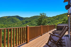 A secluded mountain property surrounded by lush forested hills offers peaceful natural beauty and scenic views.