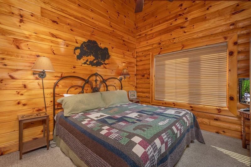 King bed and two night stands in a bedroom at Gone Fishin, a 2bedroom cabin rental located in Pigeon Forge