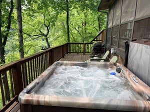 Soak in the bubbling hot tub on your private deck, surrounded by lush forest views. Perfect for unwinding after a day of mountain adventures.