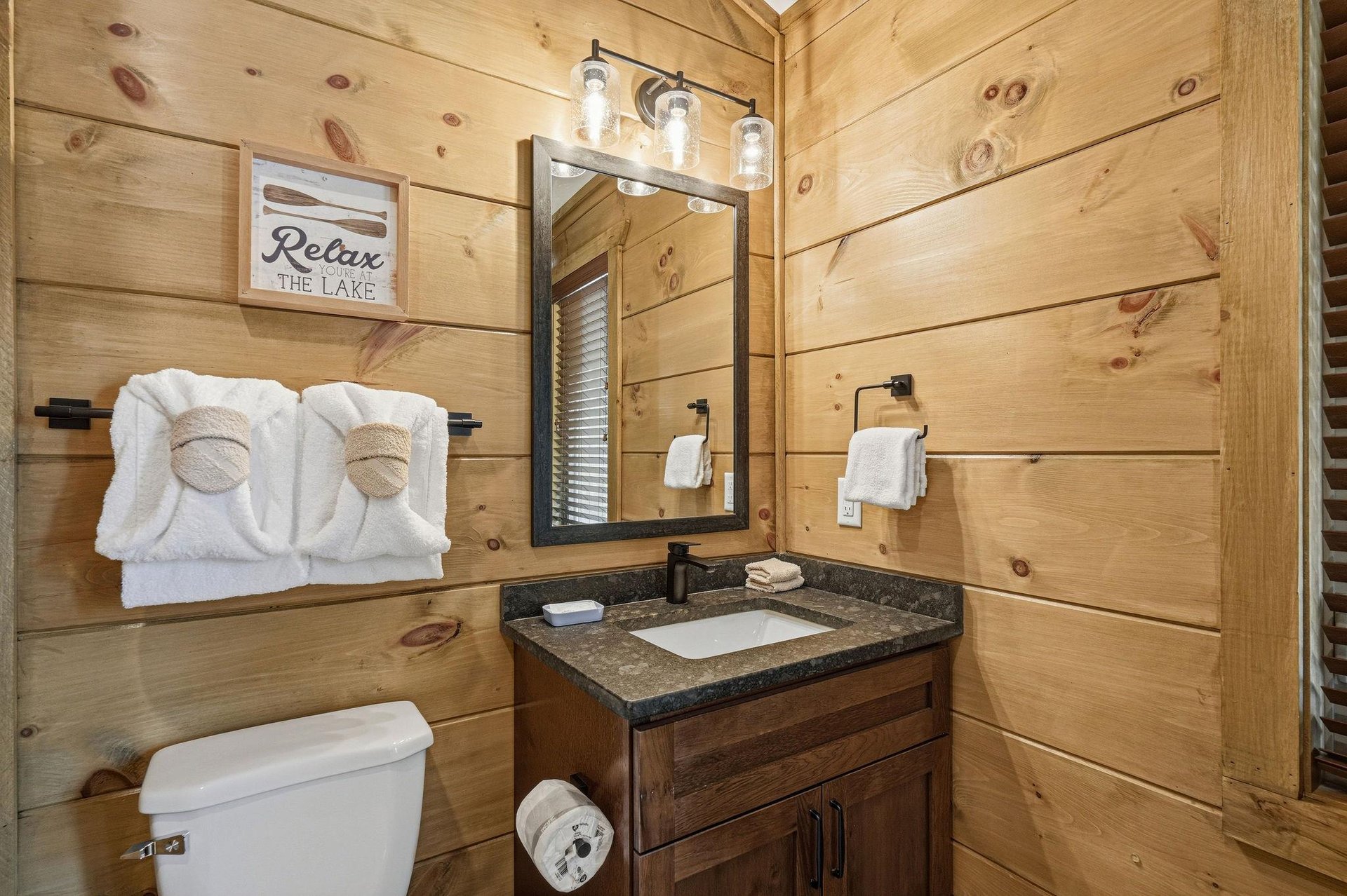 Rustic charm meets modern comfort in your private bathroom, complete with fluffy towels and thoughtful lakethemed touches.