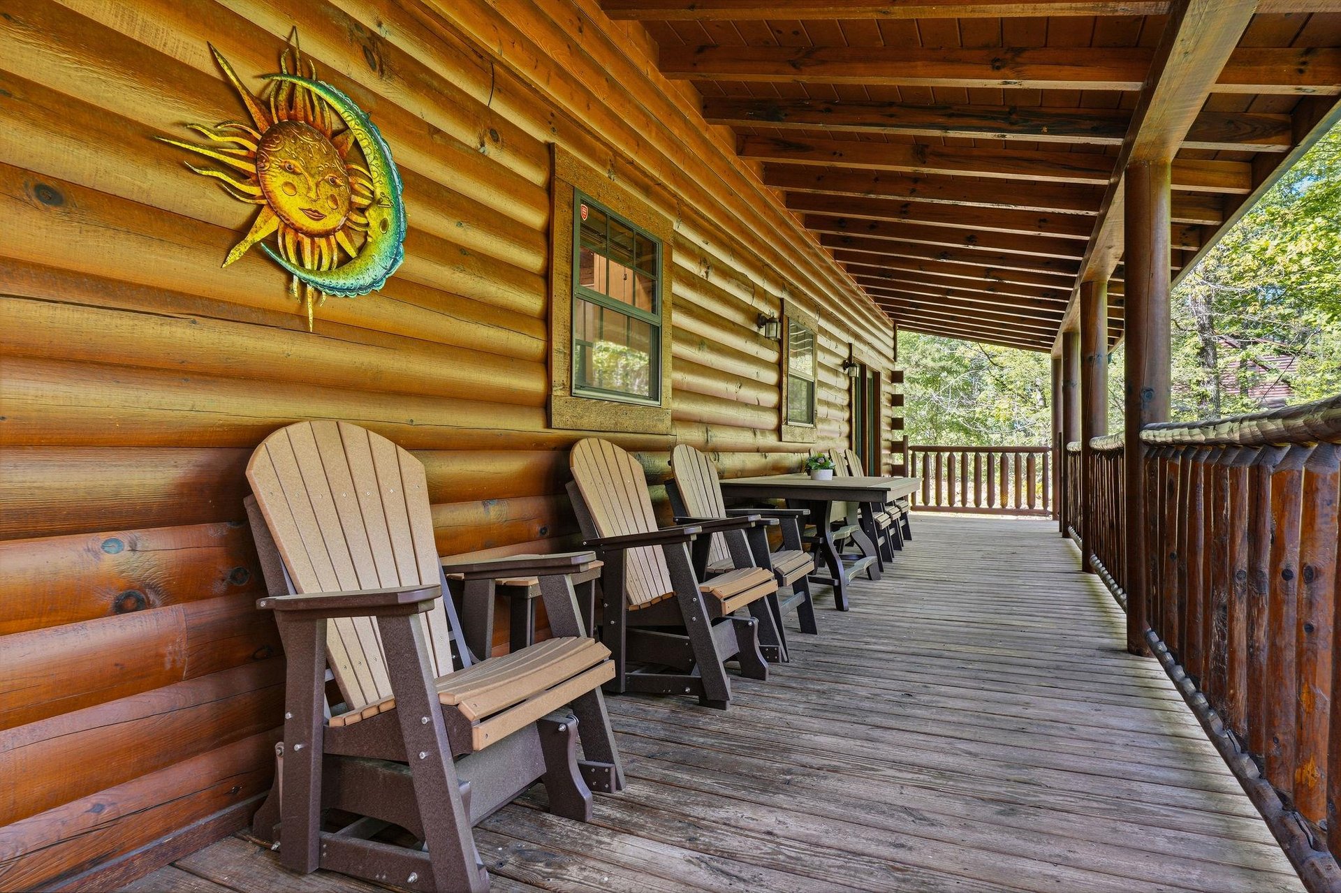 Unwind on your private covered deck with rustic Adirondack chairs and charming sunmoon artwork adorning the log cabin walls.