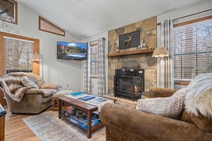 Sink into plush seating by your crackling fireplace, where cozy throws and warm lighting create the perfect retreat after mountain adventures.