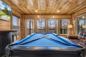 Challenge friends to billiards in your rustic game room with soaring wood ceilings and panoramic windows.