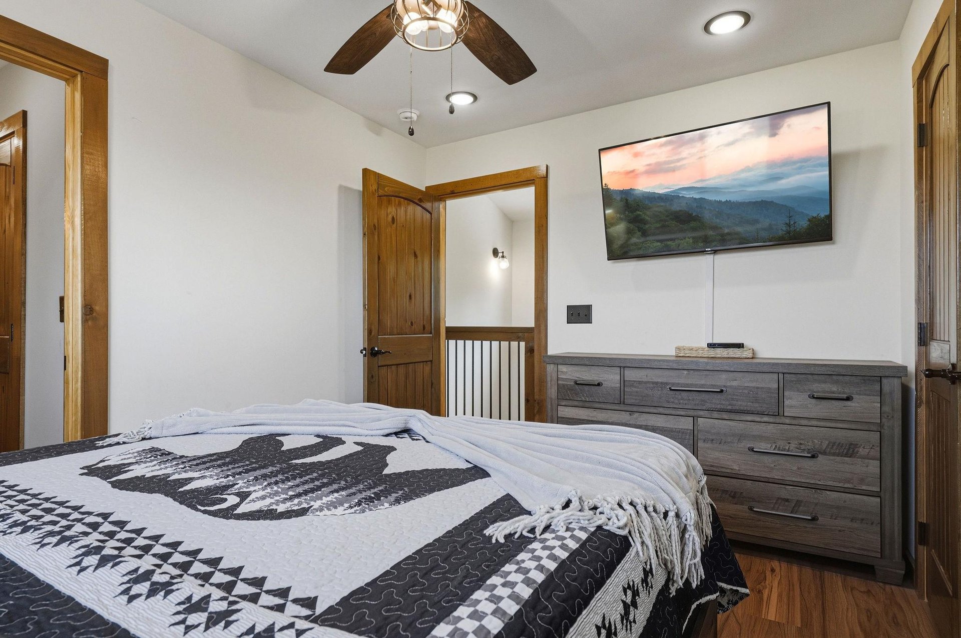 Unwind in your serene retreat, where rustic wood beams and thoughtful decor create a restful escape after a day of mountain adventures.