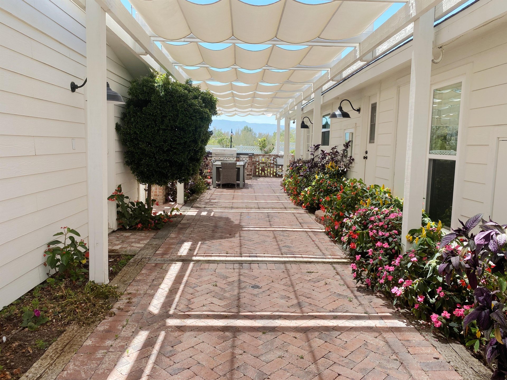Grand flowerlined walkway leading to the front door.