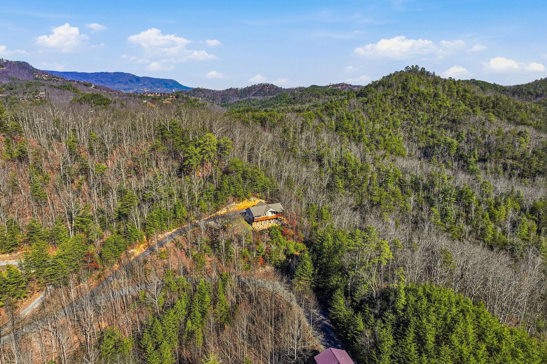 Secluded mountain retreat nestled among rolling forested hills, offering complete privacy and stunning natural surroundings.