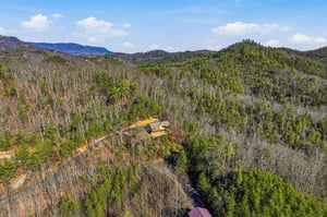Secluded mountain retreat nestled among rolling forested hills, offering complete privacy and stunning natural surroundings.