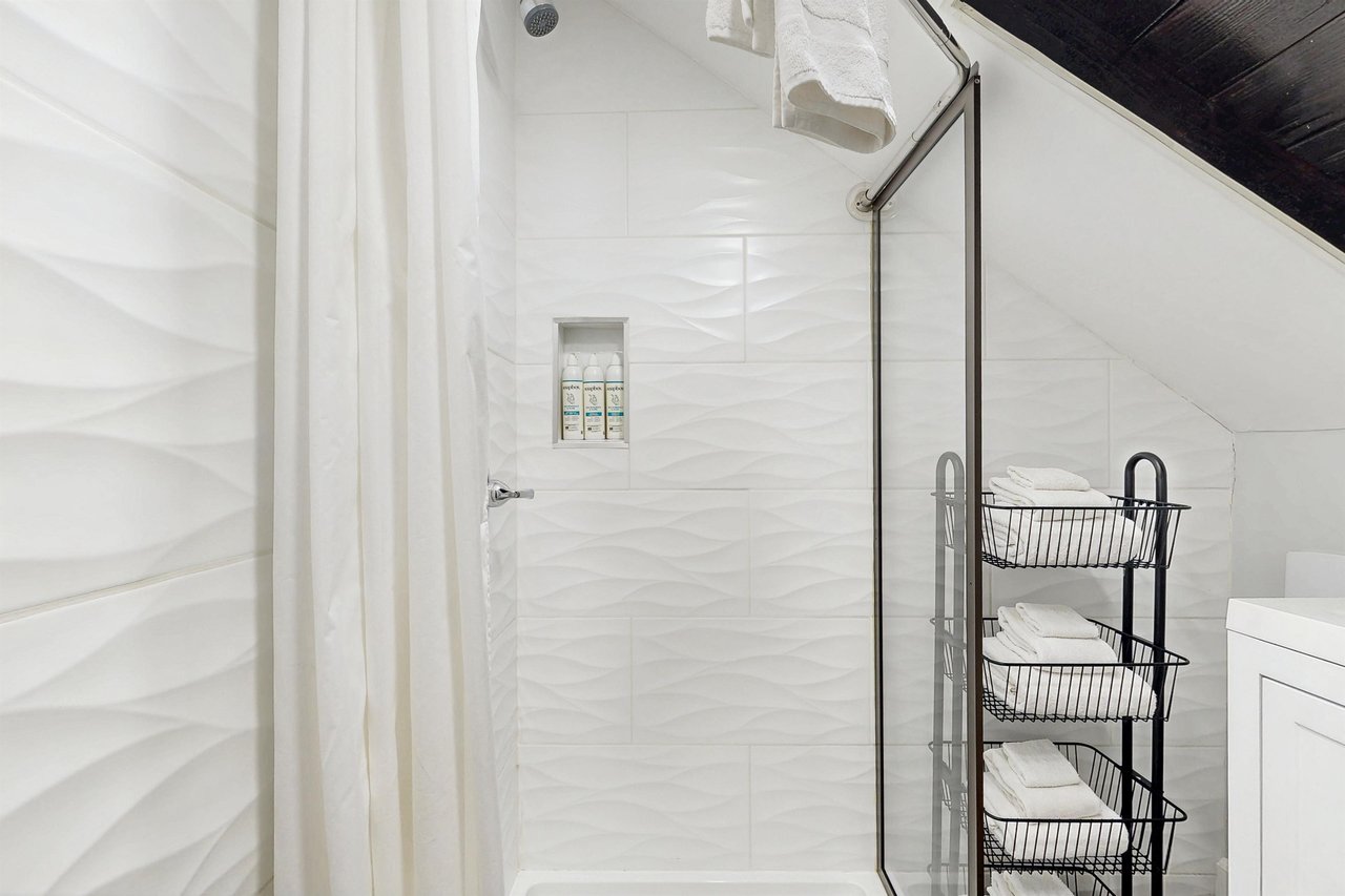Ensuite primary bathroom with stand alone shower.
