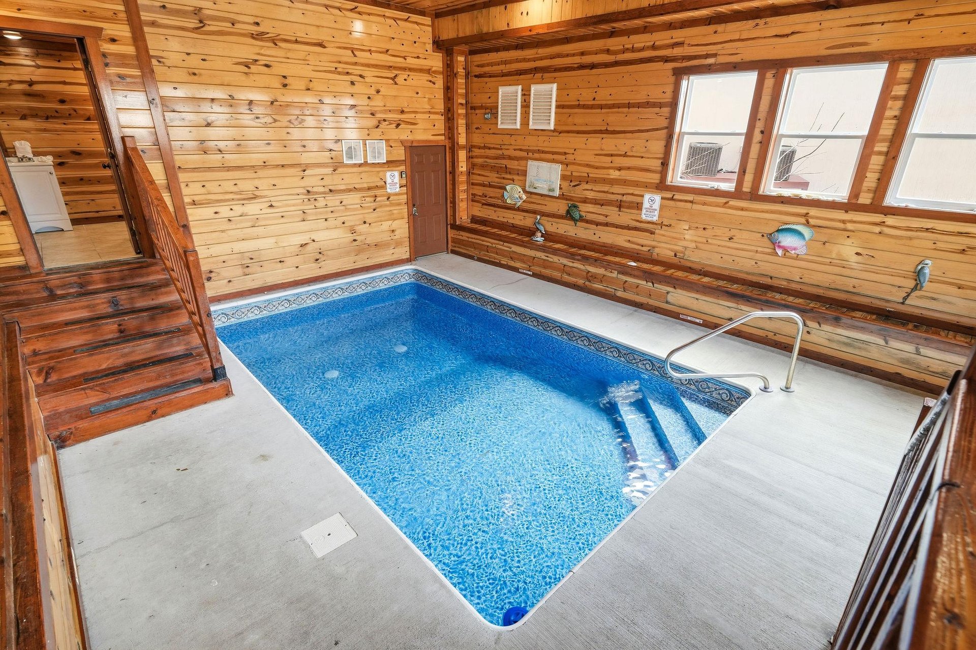 Escape to your private indoor pool sanctuary, surrounded by warm cedar walls and natural light streaming through large windows.