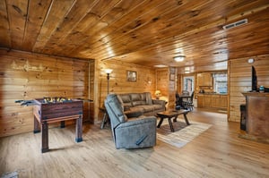 Relax in your cozy cabin with warm wood walls, plush recliners, and a fun foosball table for evening entertainment.